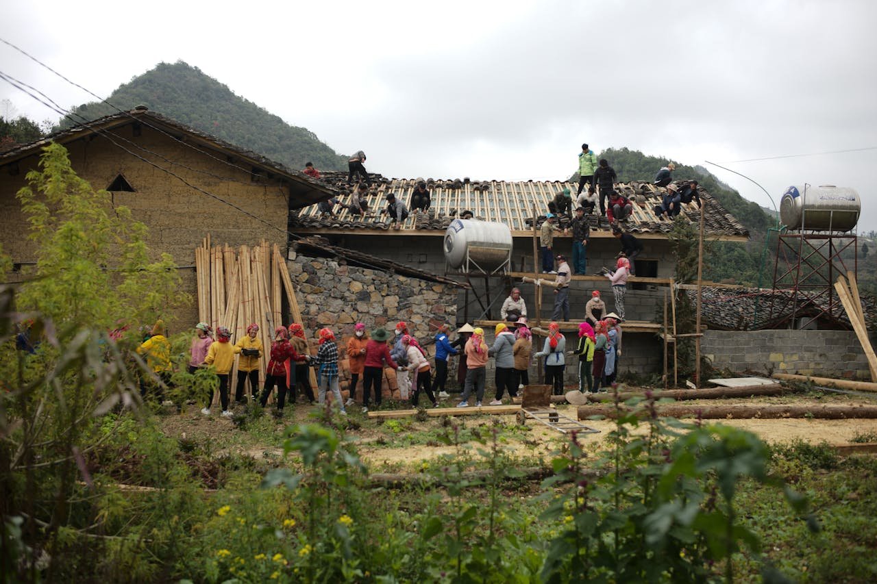 Locals participate in a communal house construction in rural Ha Giang, Vietnam.